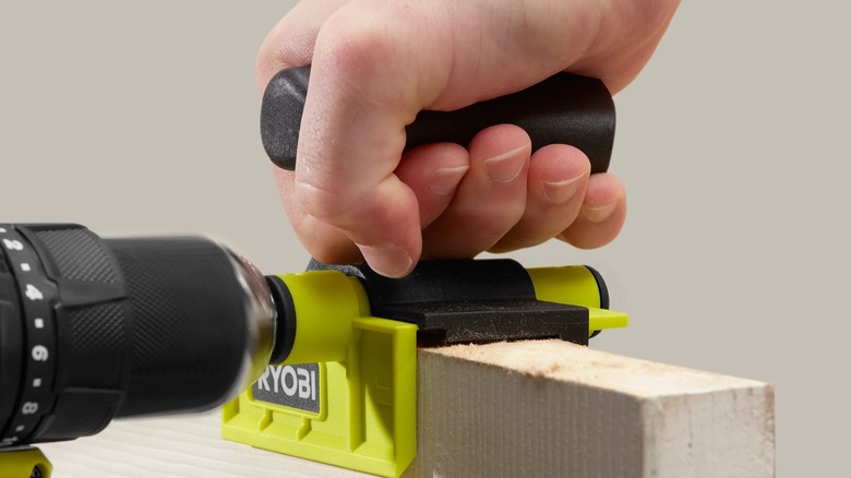 A person using a Ryobi door trimmer