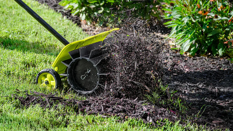 Ryobi Expand-It Rubber Broom attachment sweeping turf
