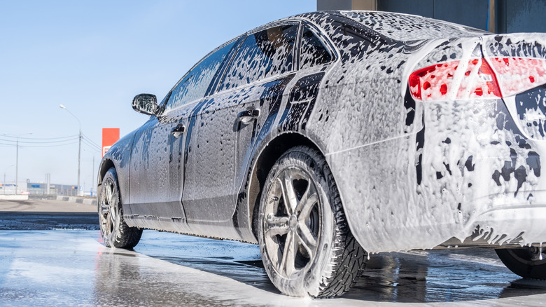 A car covered in cleaning foam