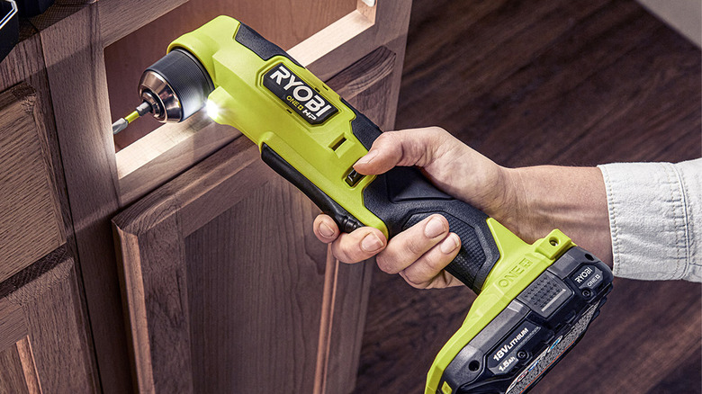 person using ryobi drill