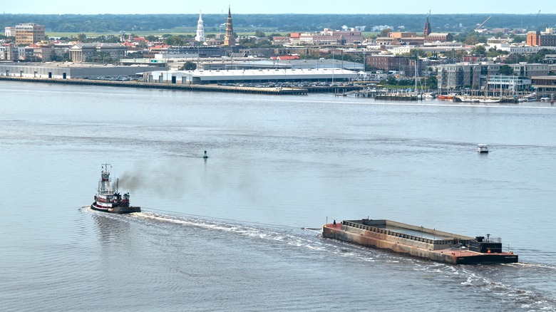 Tugboat towing a larger ship