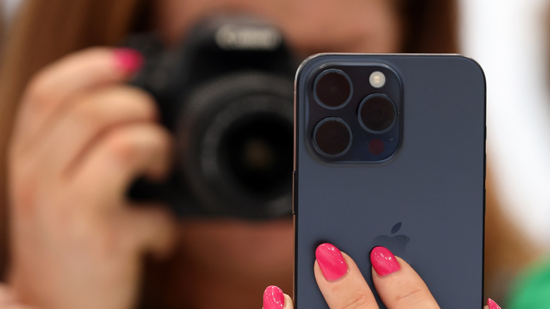 Person clicking photo of an iPhone