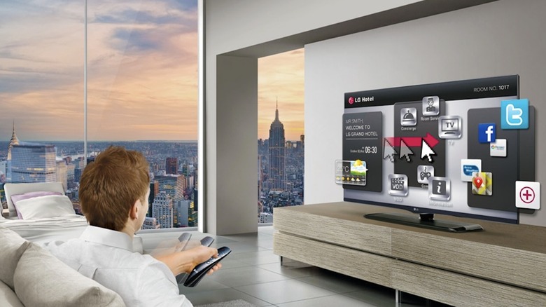Person accessing menu on LG TV in a hotel room