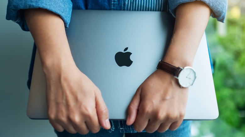 MacBooks in hands