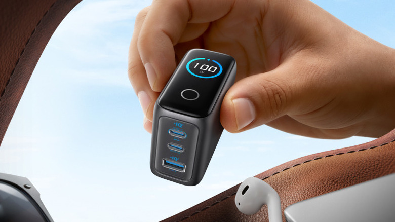 Hand holding Anker 100W charger