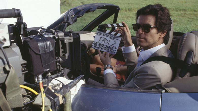 Pierce Brosnan filming in a car