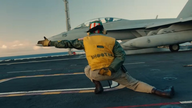 A "shooter" signaling catapult launch of a fighter jet