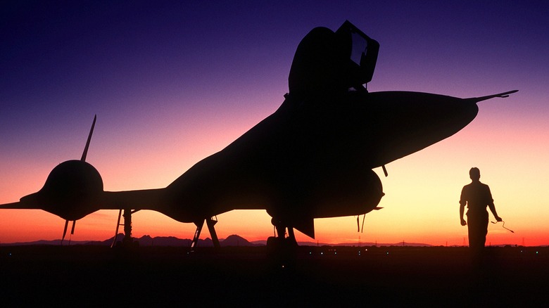 A silhouetted view of an AR-71B at sunset