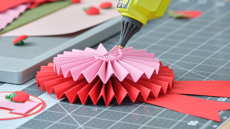 person using ryobi pink glue stick