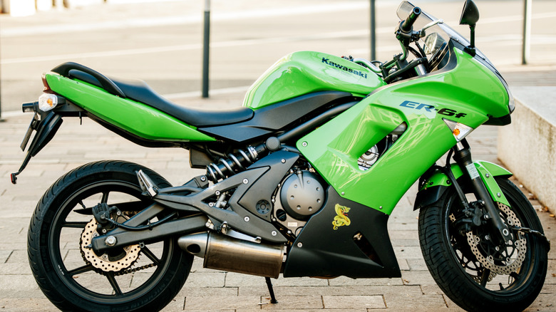 Green Kawasaki Moto Pulsion motorcycle parked on the street
