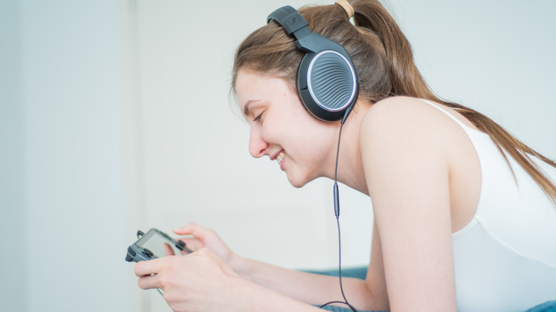 person using Nintendo Switch with headphones