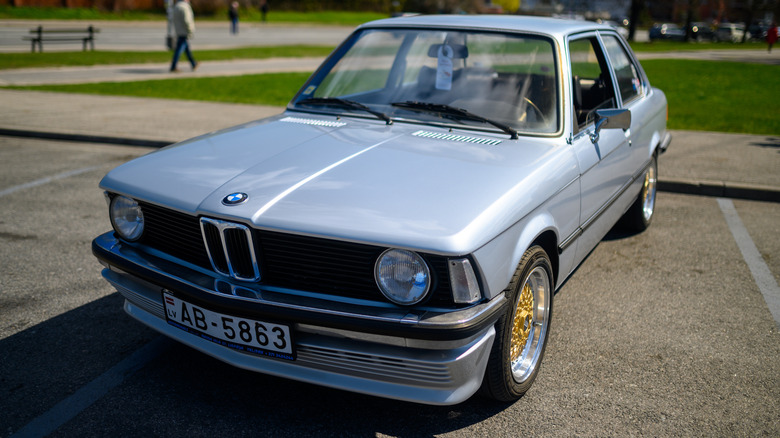 A first-generation BMW 3 Series E21 in parking lot