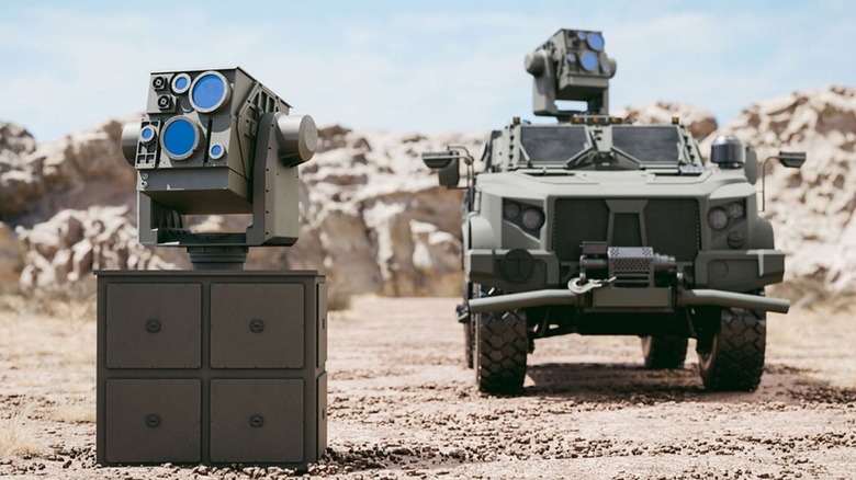 One Locust X3 laser air defense system on the ground and another mounted atop a Joint Light Tactical Vehicle