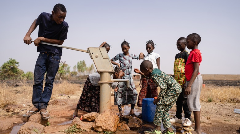 Villagers gathering well water