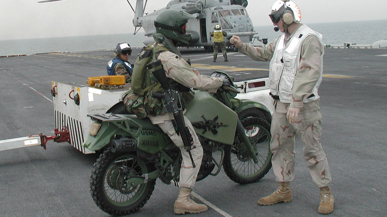 Marine on bike speaking to pilot