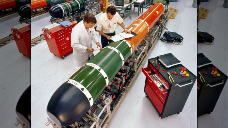 Workers performing maintenance on a Mk. 48 heavyweight torpedo
