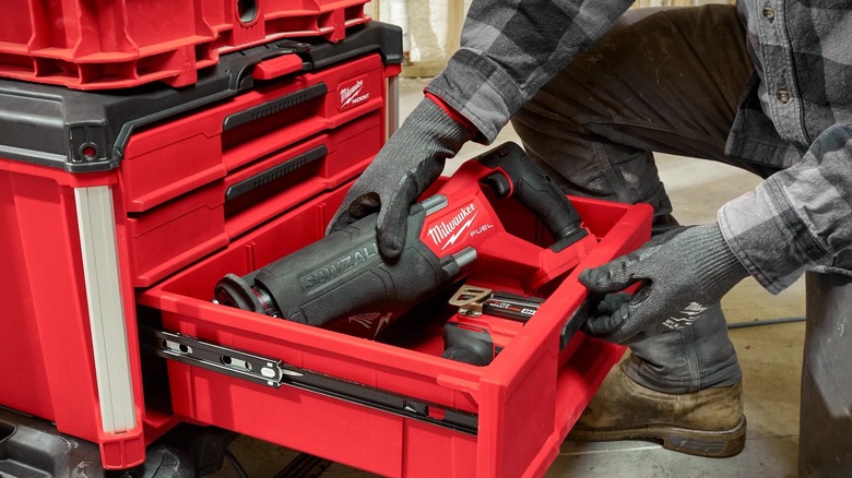 Person putting tools in a Packout multi-drawer box.