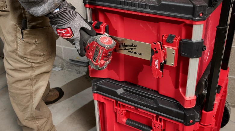 Person hanging tools on a Packotu rack clip.