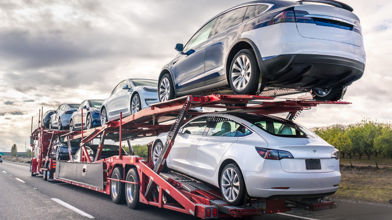 tesla cars being delivered on truck