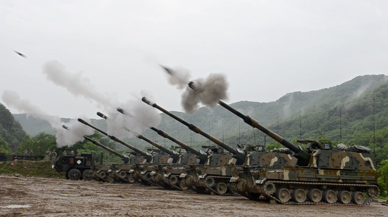 A battery of six K9 Thunder self-propelled howitzers firing their cannons in South Korea