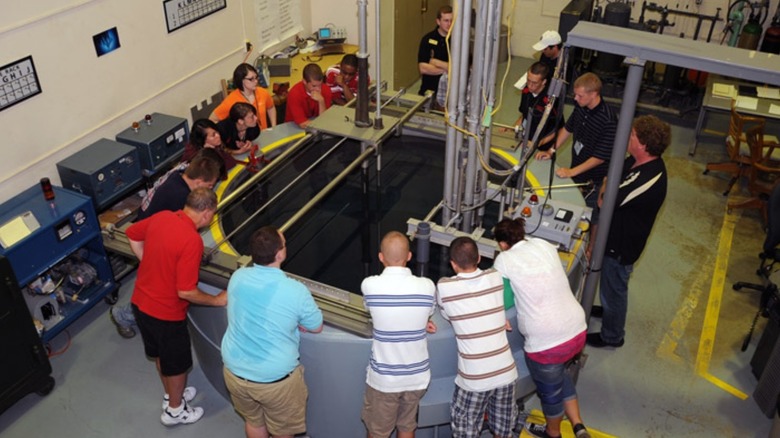A group gathered around PUR-1 equipment.