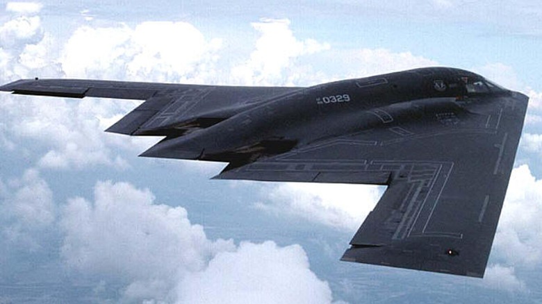 A B-2 Spirit flying over cloudy skies