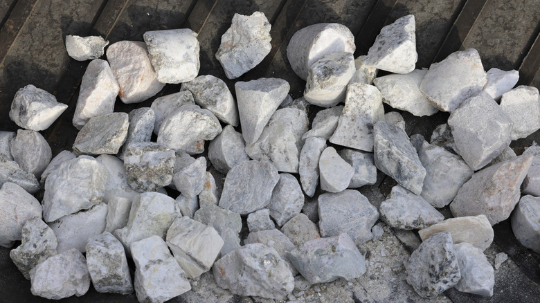 Close-up of spodumene hard rock ore on a conveyor belt.
