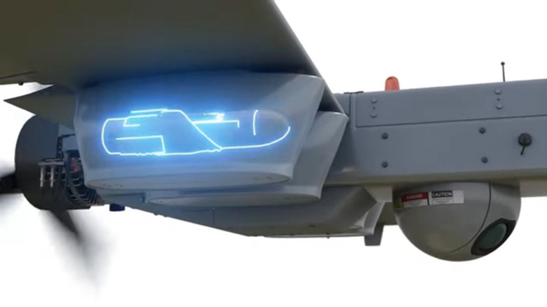 A side view of a UAS carrying a Hatchet bomblet