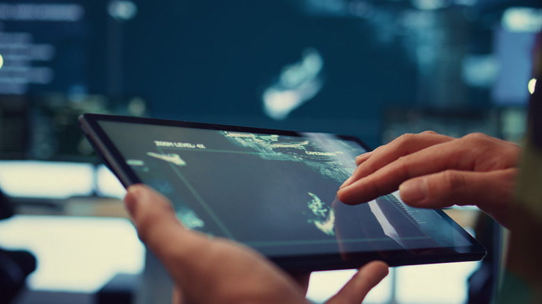 A person checking location on iPad from afar