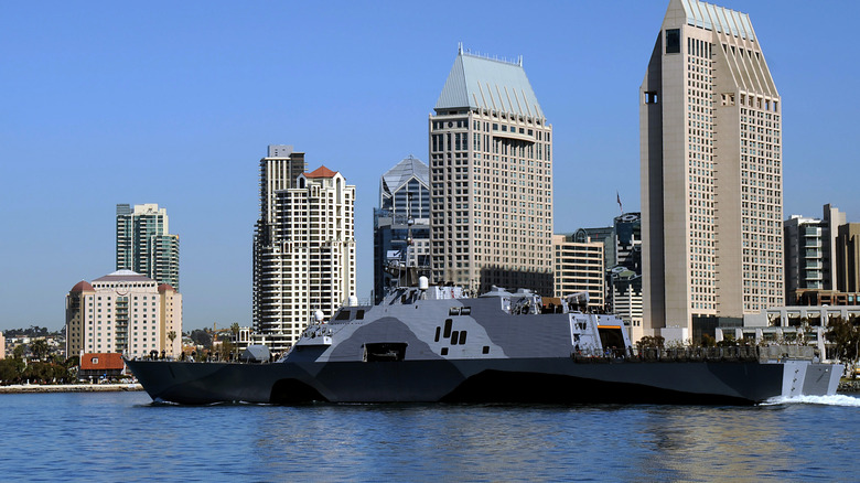 Littoral combat ship in the water near the shore.