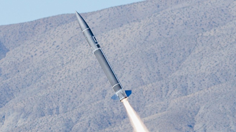 A test flight of the Blackbeard hypersonic missile in the desert with mountain background