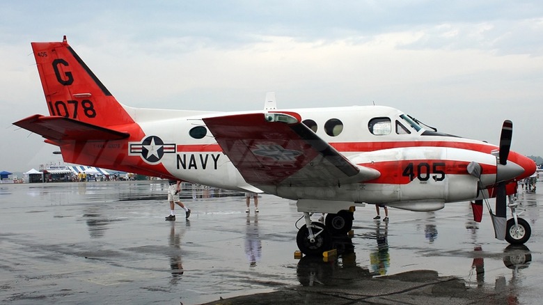 A T-44C Pegasus parked on a wet tarmac
