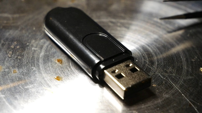 An Ovrdrive USB on a metal surface.