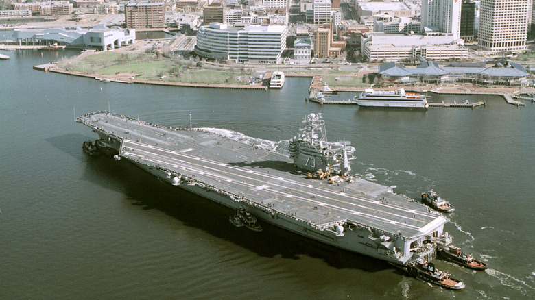 USS George Washington on the water near a port.
