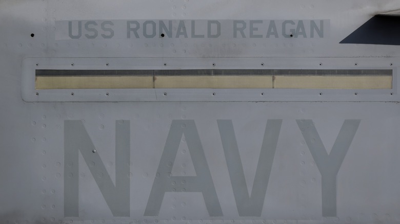 USS Ronald Reagan stenciled on the side of the carrier.