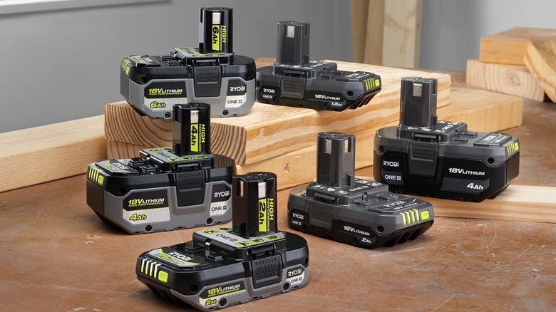 Ryobi batteries on pieces of wood.