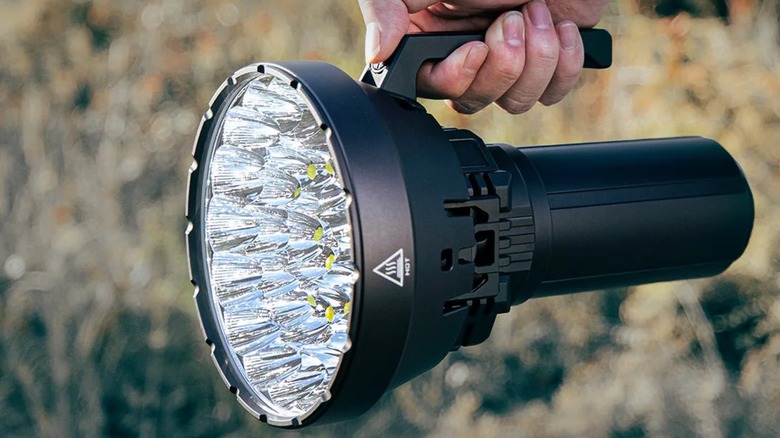 Holding the Imalent MS32 flashlight.