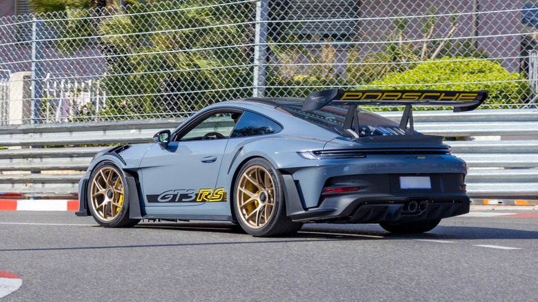 A blue Porsche 911 GT3 RS being driven through streets of Monaco.