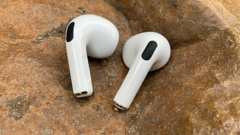 Apple AirPods 3 buds on a rock