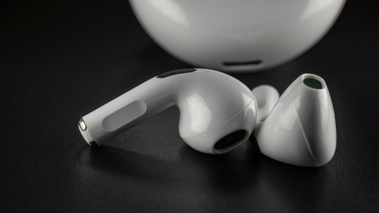 AirPods on a black surface