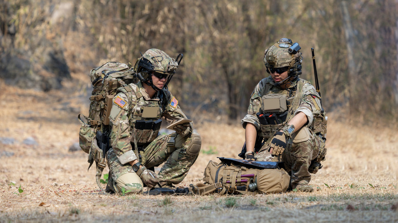 Two soldiers in training in the woods
