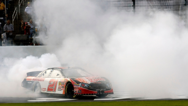 An action shot of a NASCAR Chevrolet spinning out in smoke at Texas Motor Speedway.