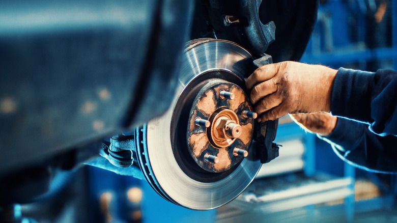 person working on brake rotor