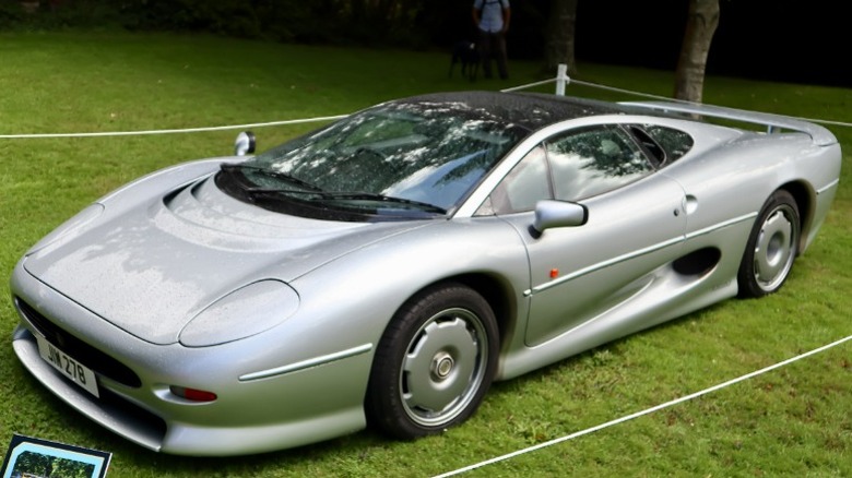 Silver Jaguar XJ220 at a car show