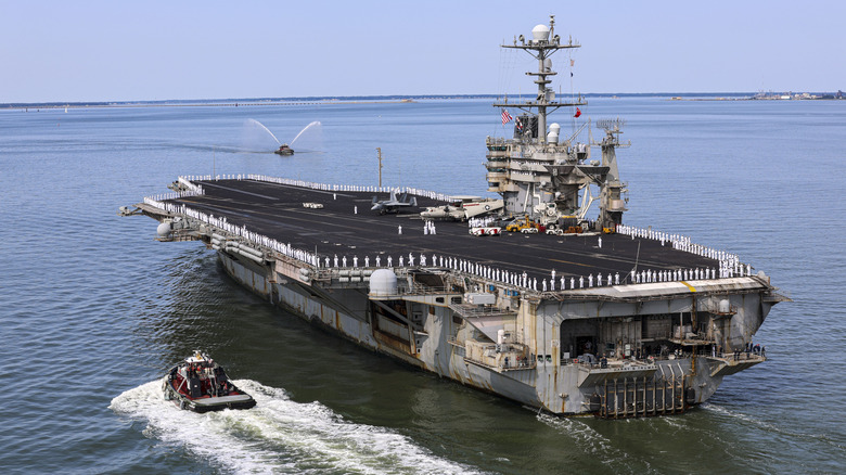 Rear view of aircraft carrier USS Harry Truman departing port.