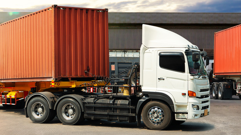 Front 3/4 view of tractor-trailer with two rear axles on cab for use with power divider switch