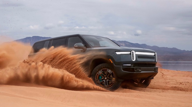 Rivian Quad driving across sand