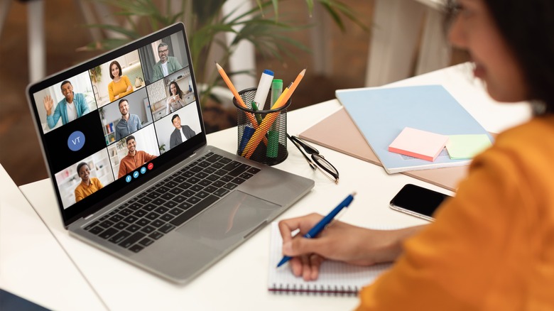 A person on a video conference with multiple people