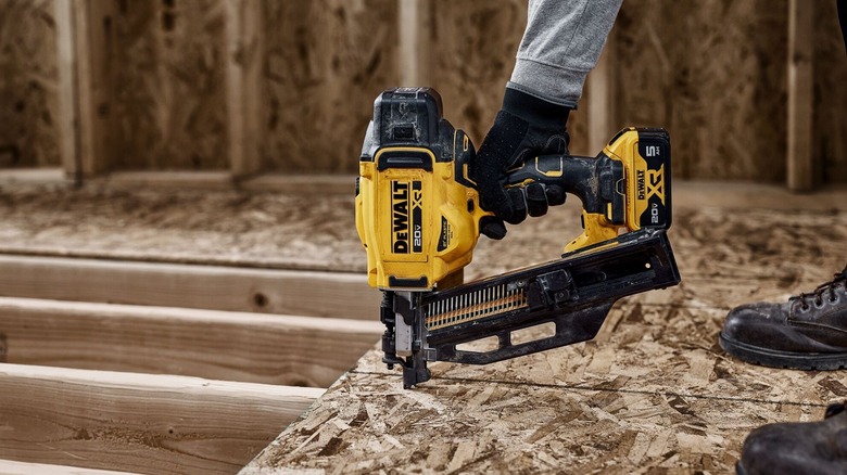 Person using DeWalt nail gun