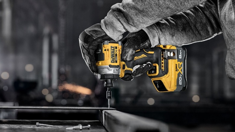 Person using DeWalt impact driver